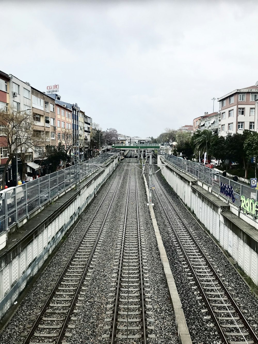 a train track with buildings in the background