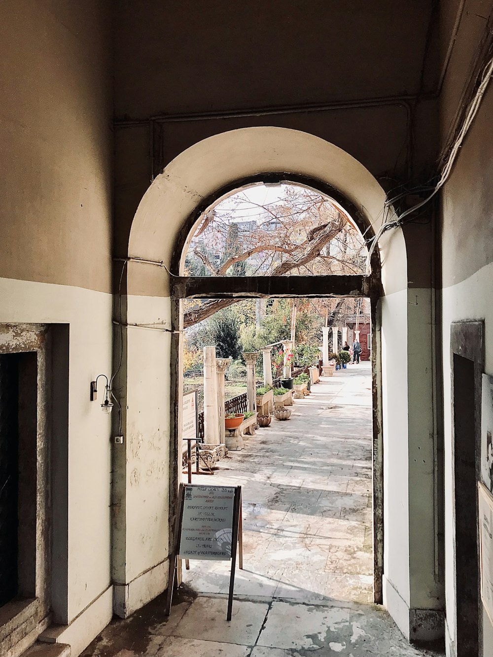 an arched doorway leading to a garden area