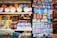 A display of various products, including packaged food items, decorative magnets, and other small merchandise. The products are neatly arranged on shelves, with colorful packaging and labels that catch the eye. On the right, a collection of magnets with images and text related to Istanbul are prominently featured.