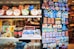A display of various products, including packaged food items, decorative magnets, and other small merchandise. The products are neatly arranged on shelves, with colorful packaging and labels that catch the eye. On the right, a collection of magnets with images and text related to Istanbul are prominently featured.