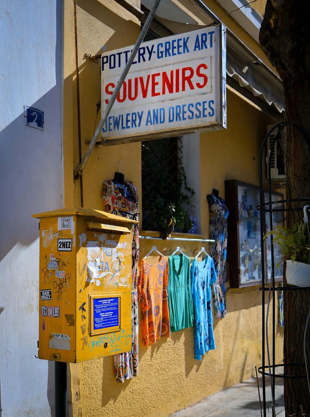 a store with a sign that says potty - fry greek art souvenirs