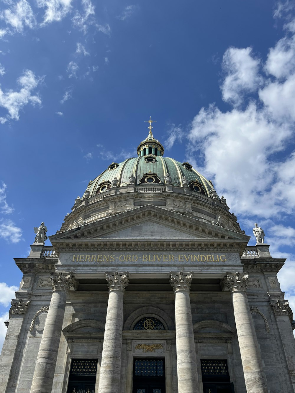 a large building with columns and a dome on top