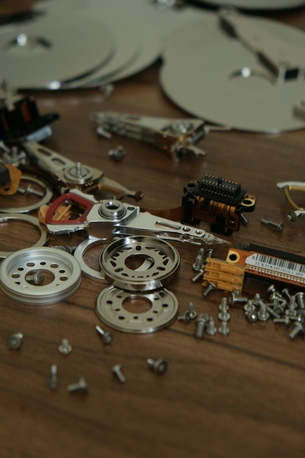 a wooden table topped with lots of assorted metal objects