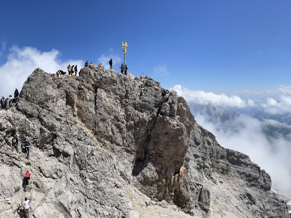 a group of people standing on top of a mountain