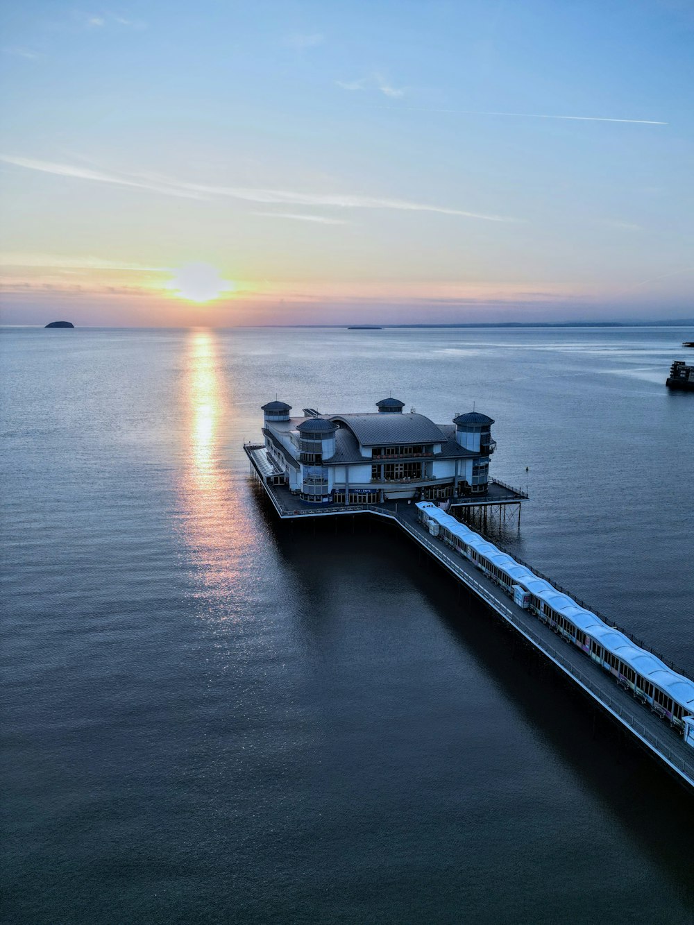 a pier with a train on it at sunset