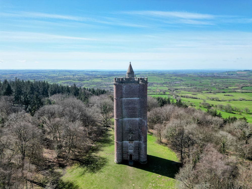 an aerial view of a tower in the middle of a field