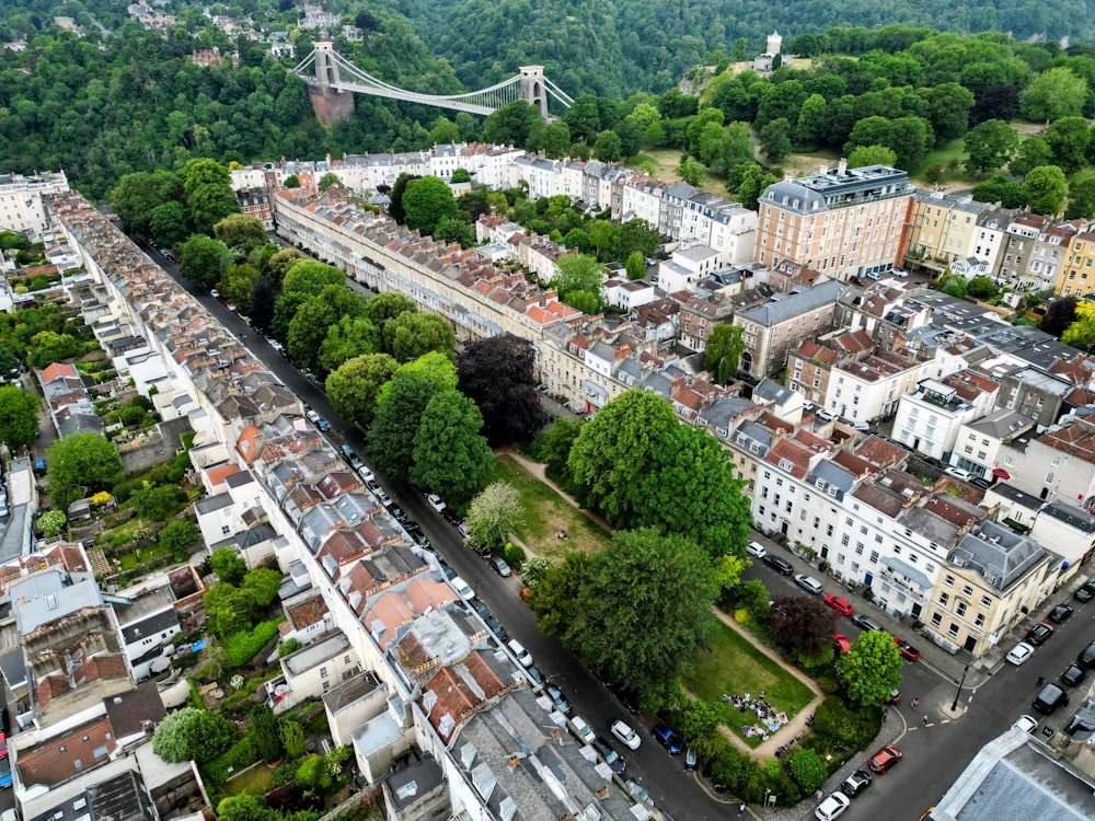 an aerial view of a city with a bridge in the background