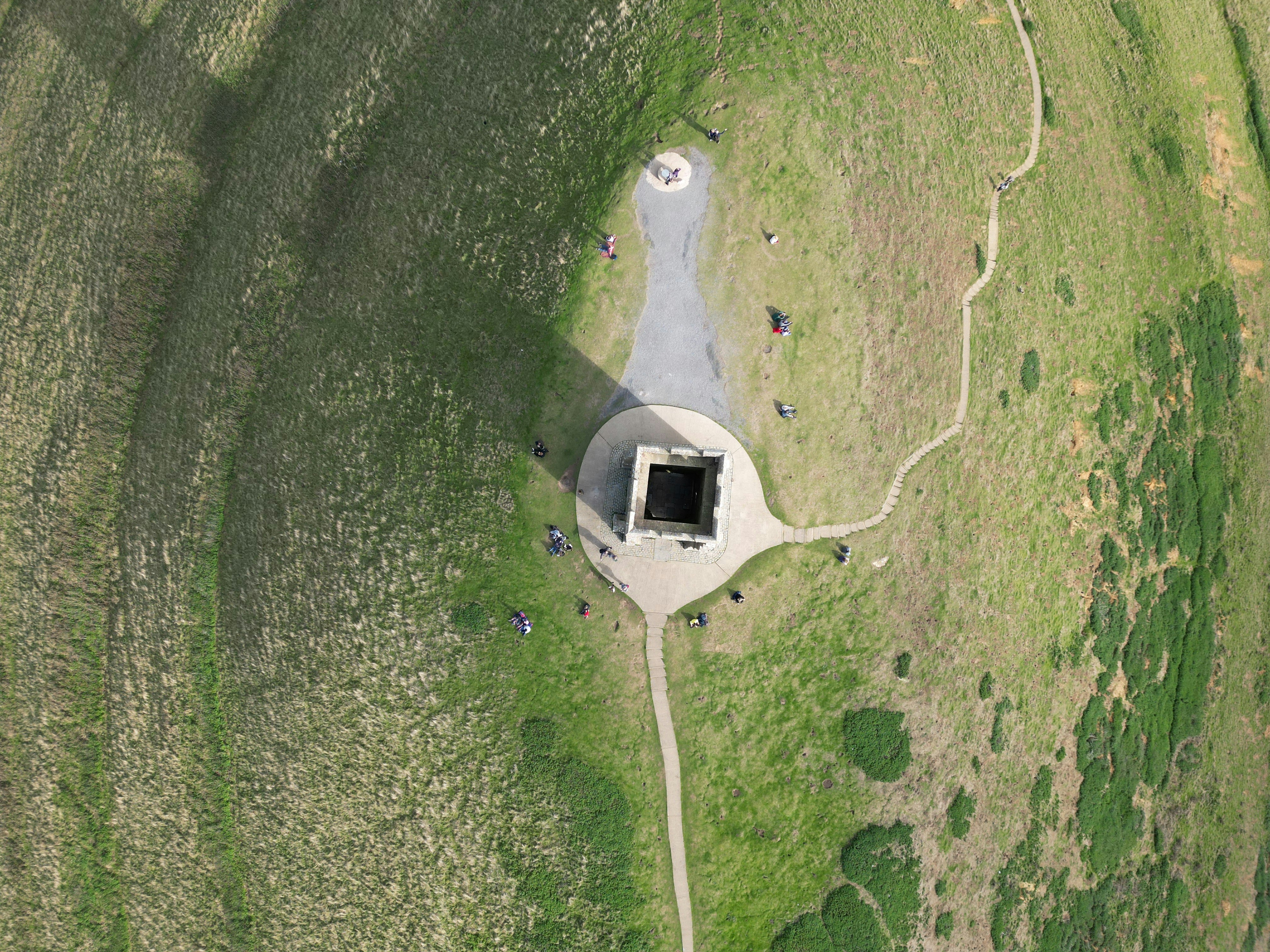 an aerial view of a building in the middle of a field