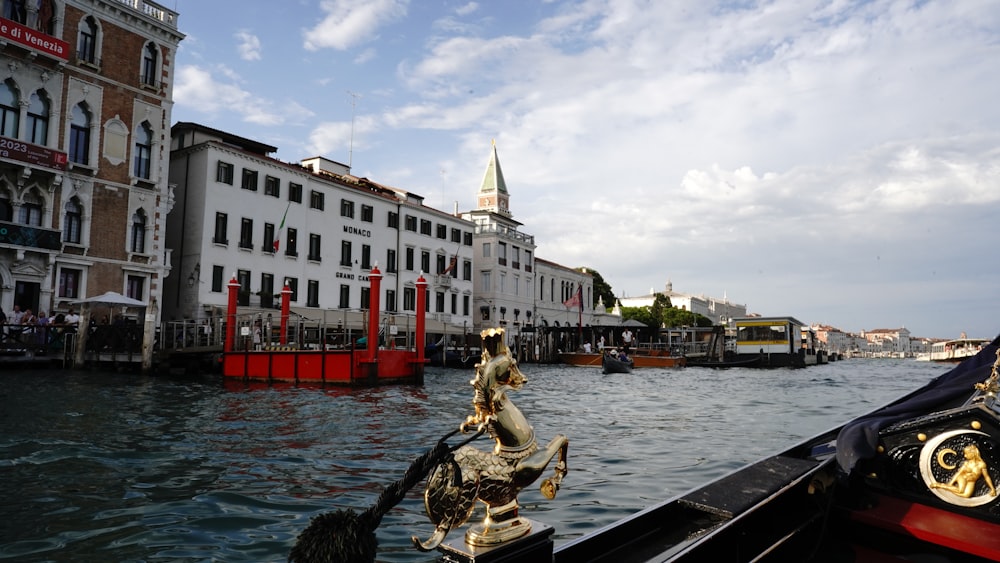 a boat traveling down a river next to tall buildings