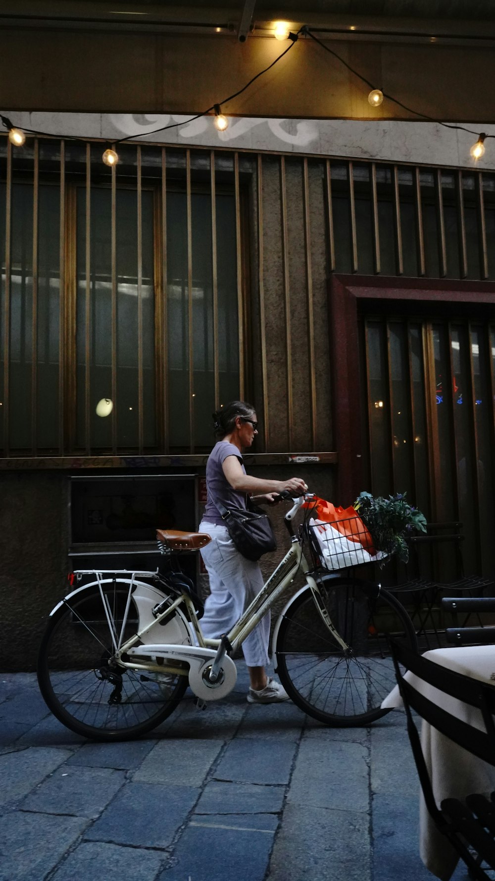 a man riding a bike down a street next to a building