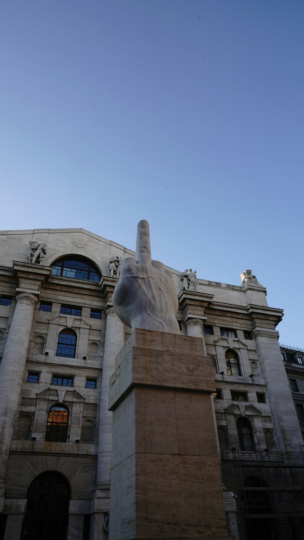 a large building with a statue in front of it