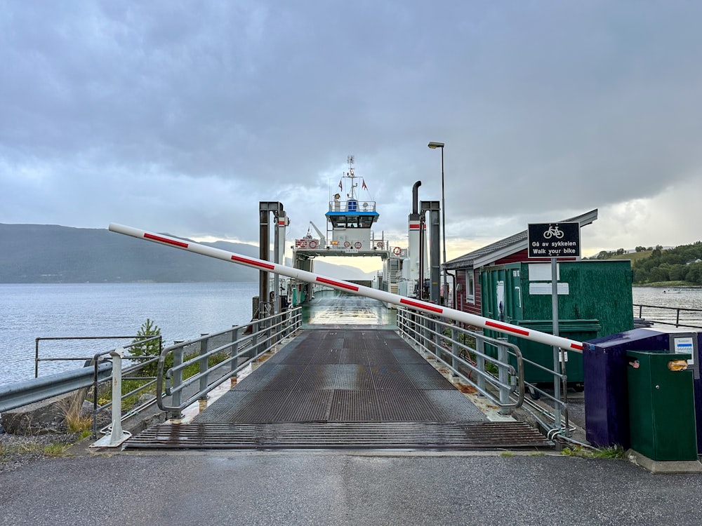 a boat is docked at the end of a pier