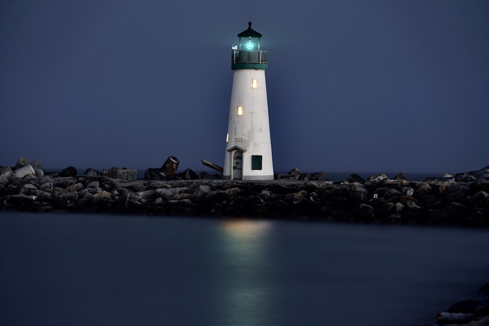 a light house sitting on top of a rocky shore