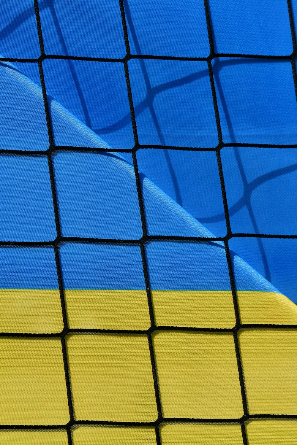 a close up of a tennis net with a blue sky in the background