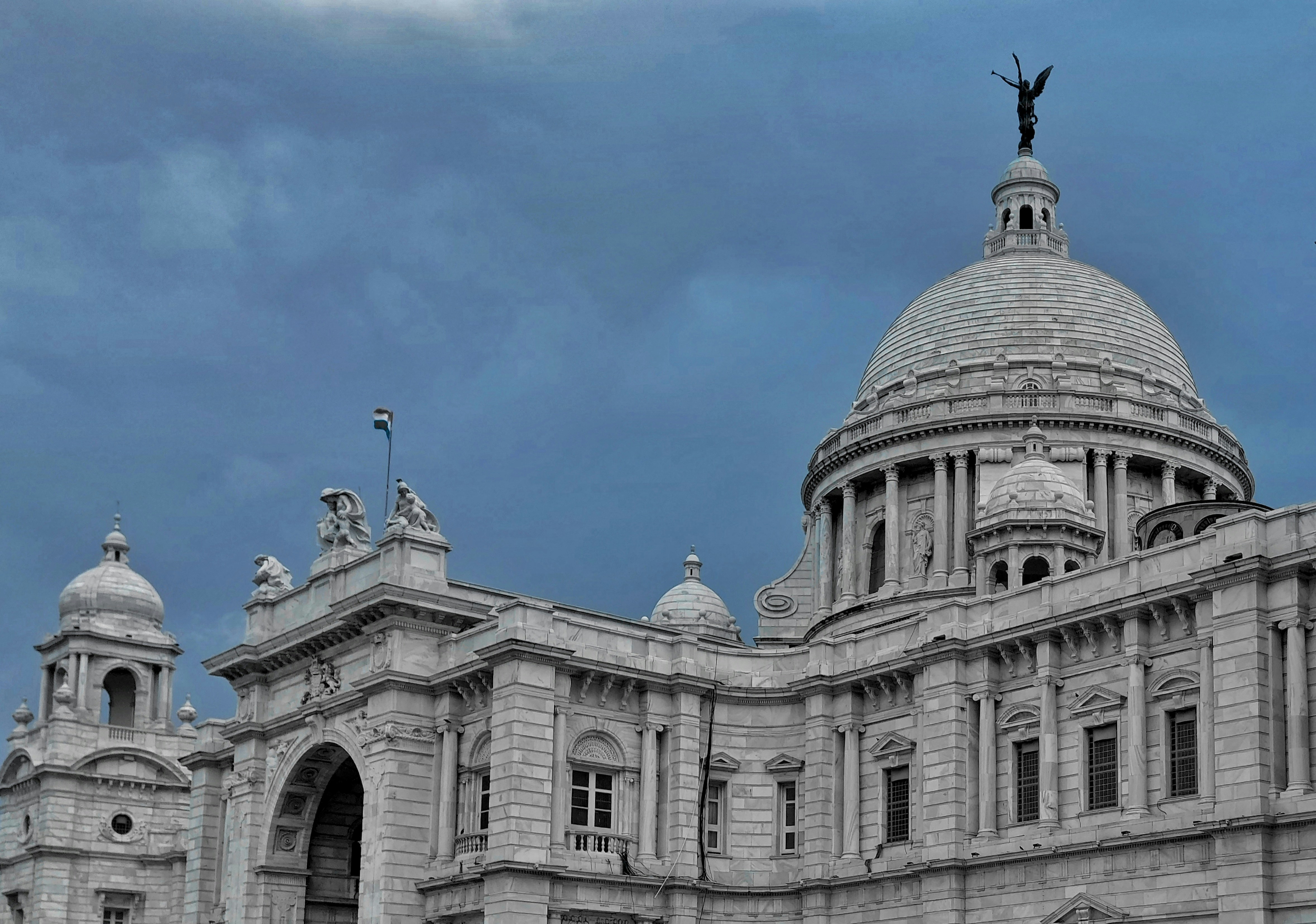 a large building with a statue on top of it
