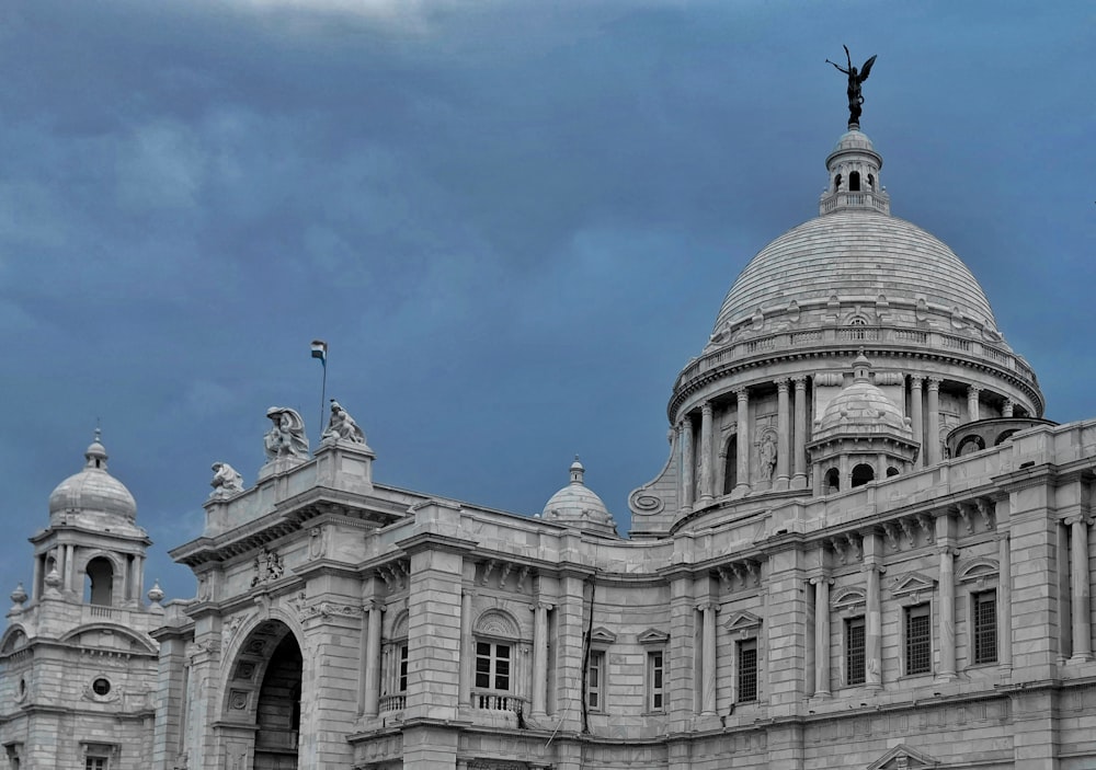 a large building with a statue on top of it