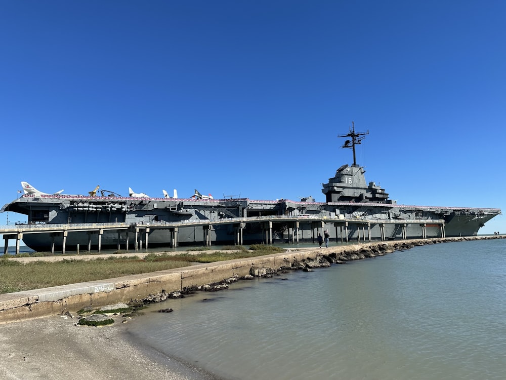 a large aircraft carrier sitting on top of a body of water