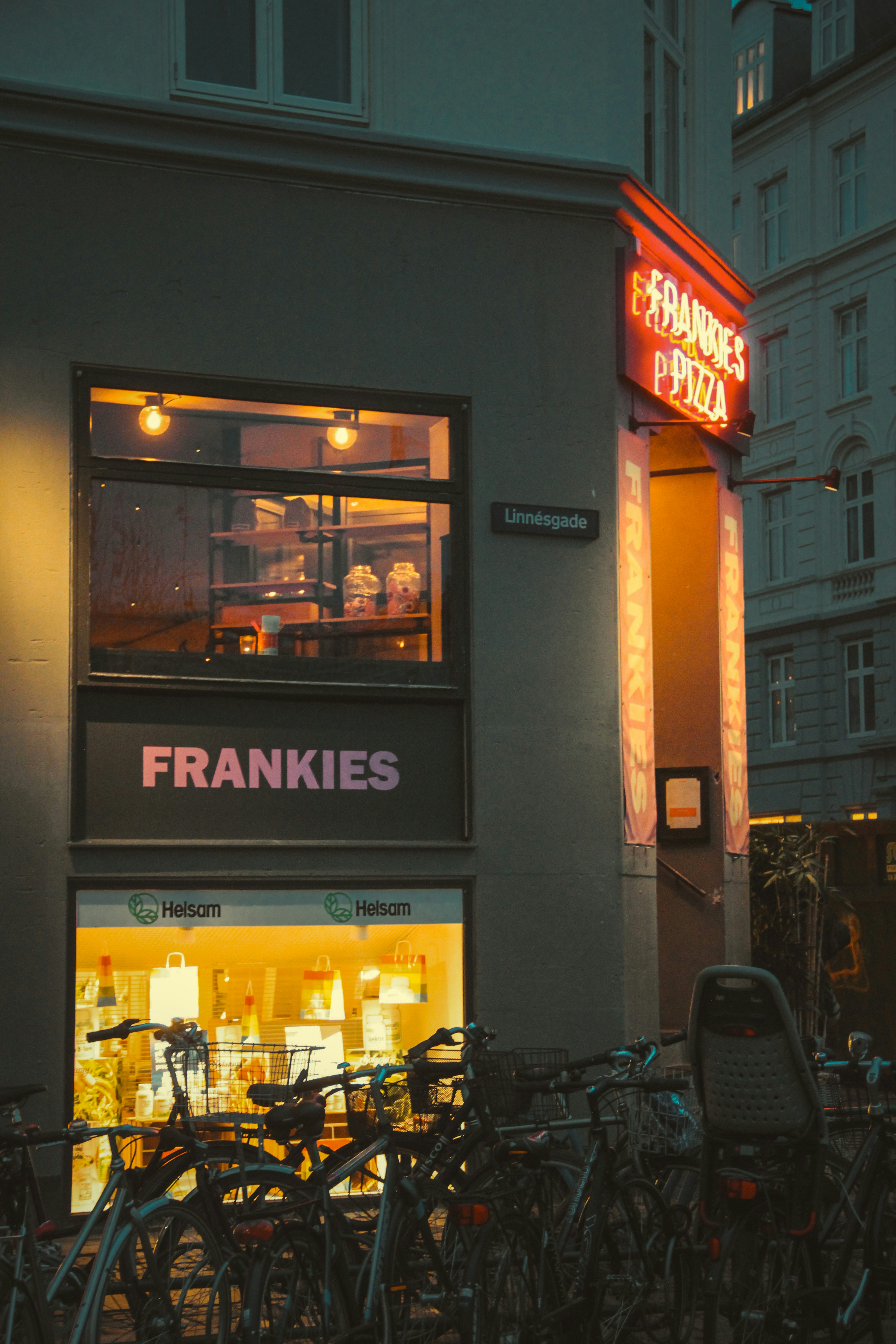 a bunch of bikes parked outside of a store