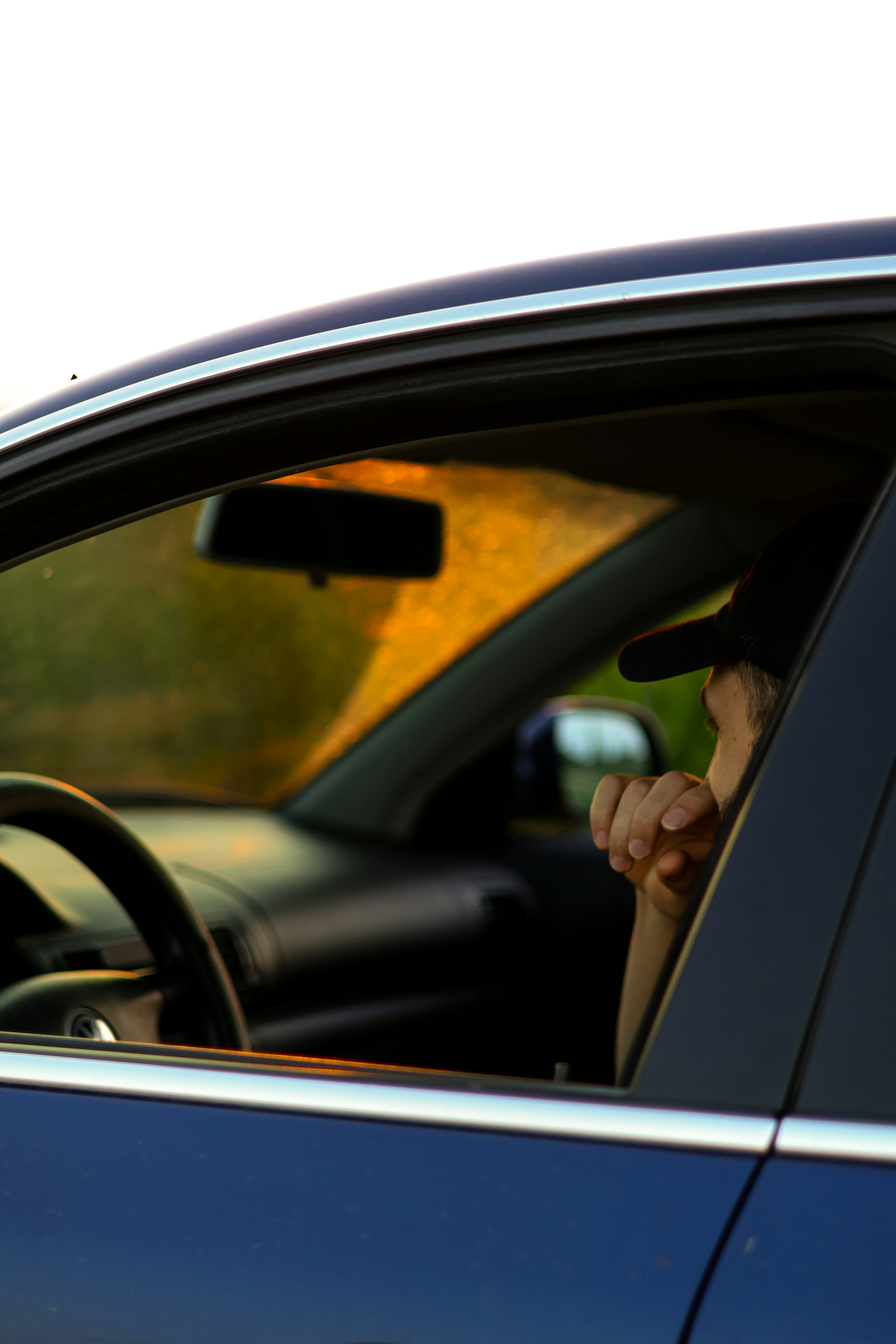 a woman sitting in a car talking on a cell phone