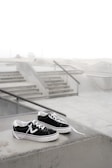Limited edition sneakers with sleek design placed on a concrete ledge.