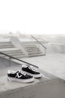 Stylish skate shoes on a concrete ledge with graffiti background.