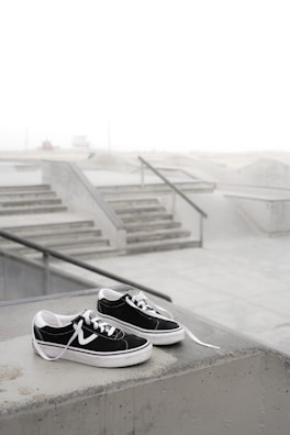 Limited edition sneakers with sleek design placed on a concrete ledge.