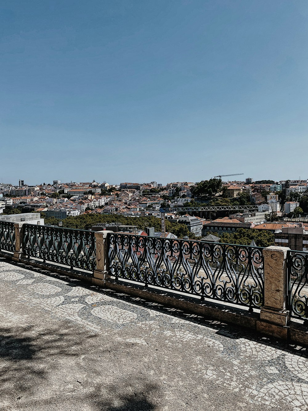 a person sitting on a bench overlooking a city