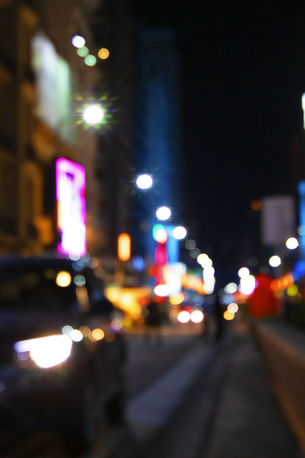 a blurry photo of a city street at night