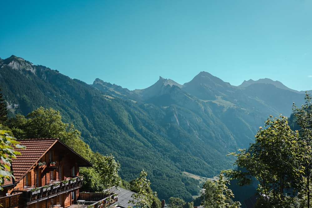 a view of a mountain range with a house in the foreground