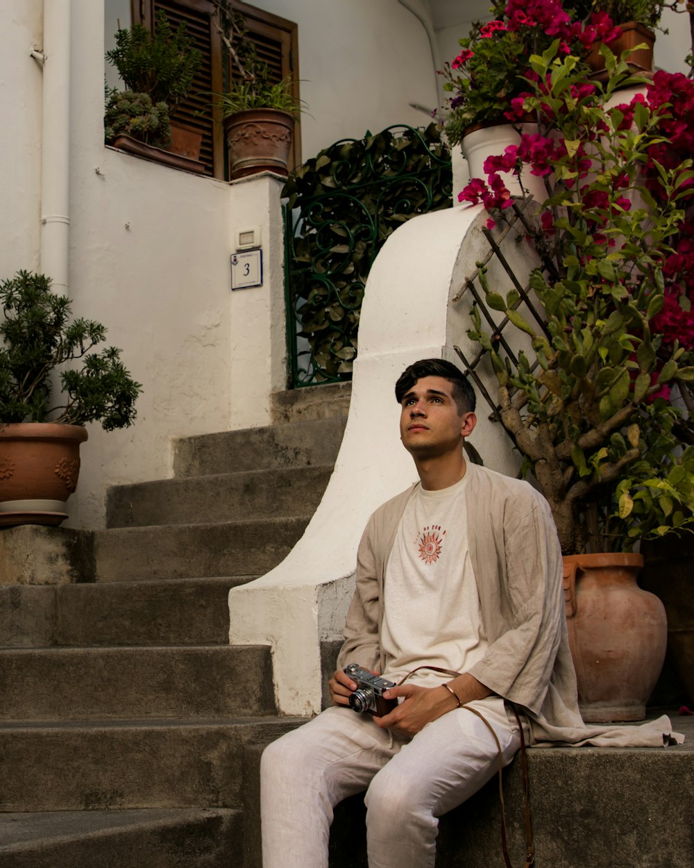 a man sitting on the steps of a building