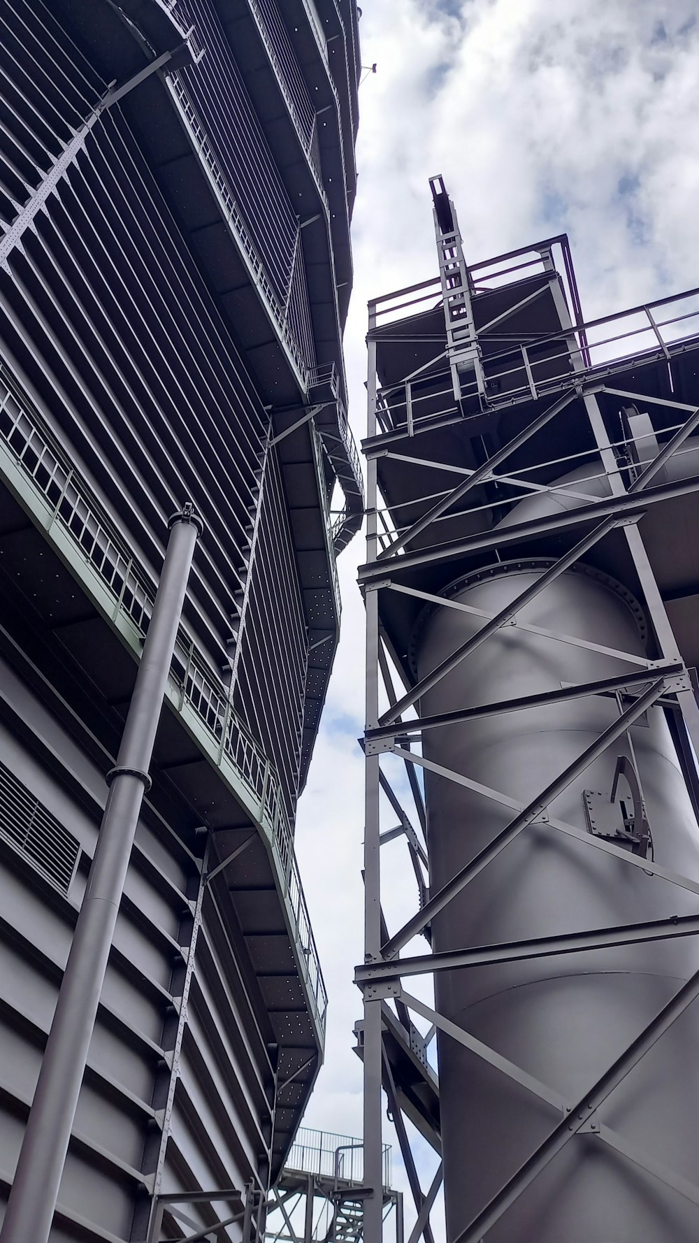a tall metal structure next to a tall building
