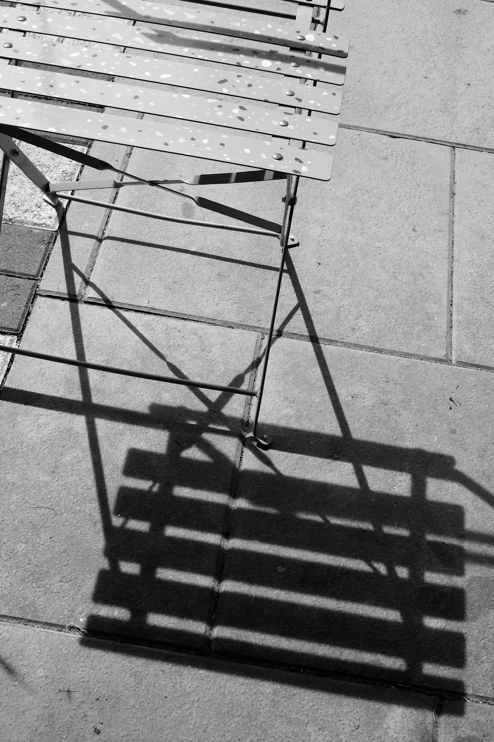 a wooden bench sitting on top of a sidewalk