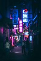 a group of people standing outside of a building at night