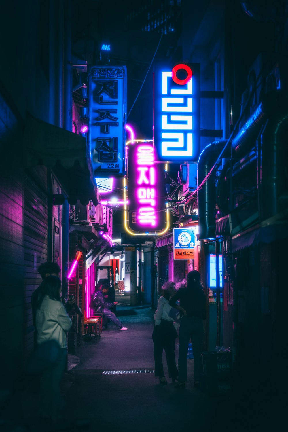 a group of people standing outside of a building at night