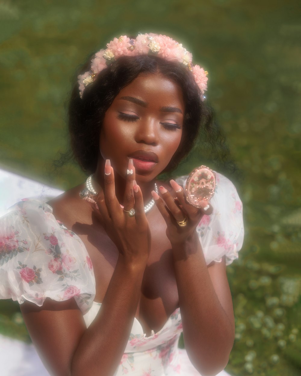 a woman in a white dress holding a donut