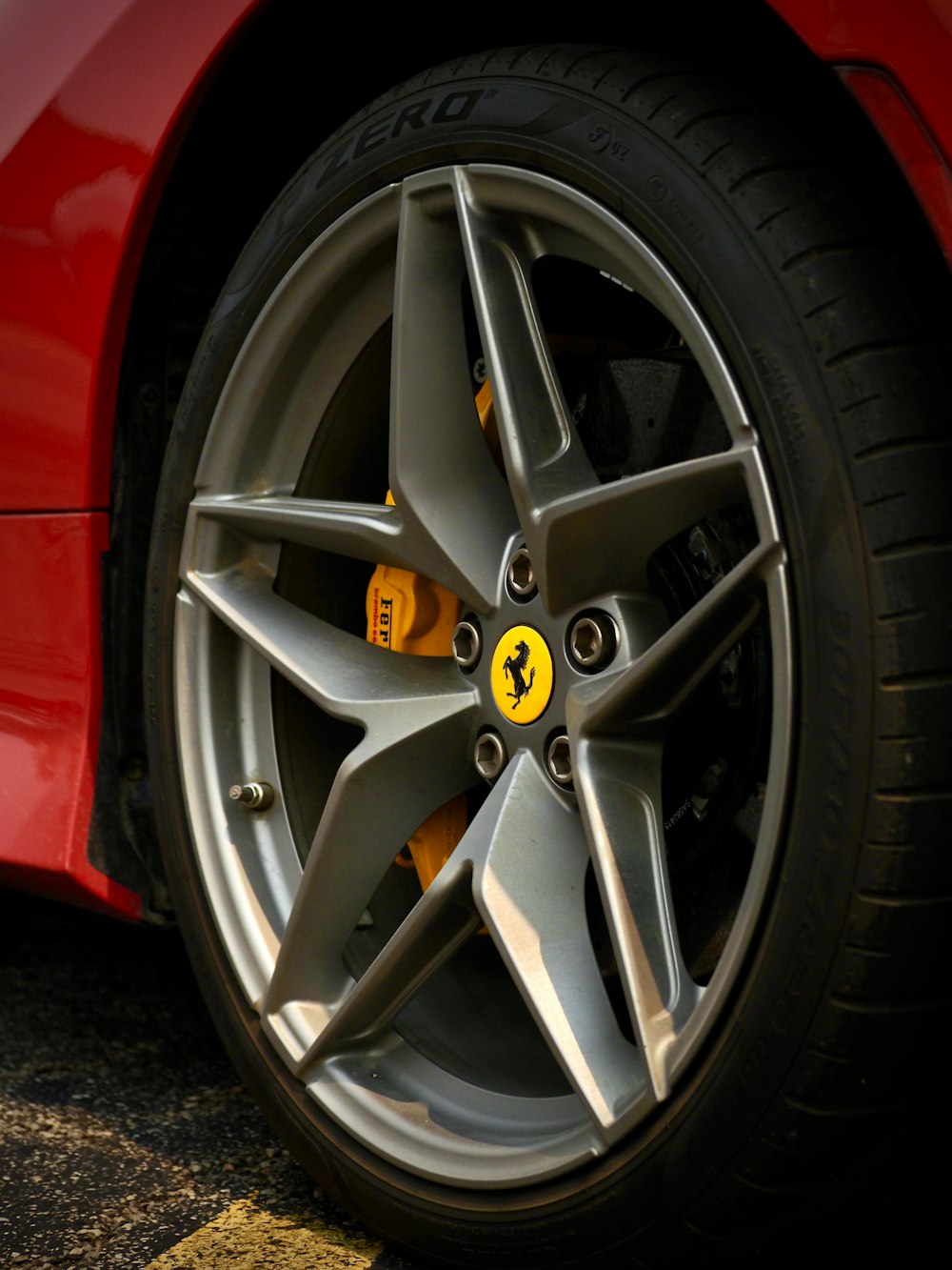 a close up of a wheel on a red sports car