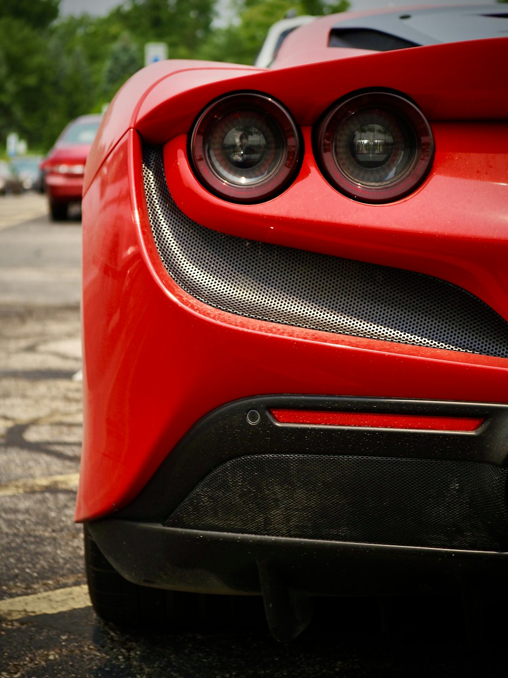 a close up of the front of a red sports car
