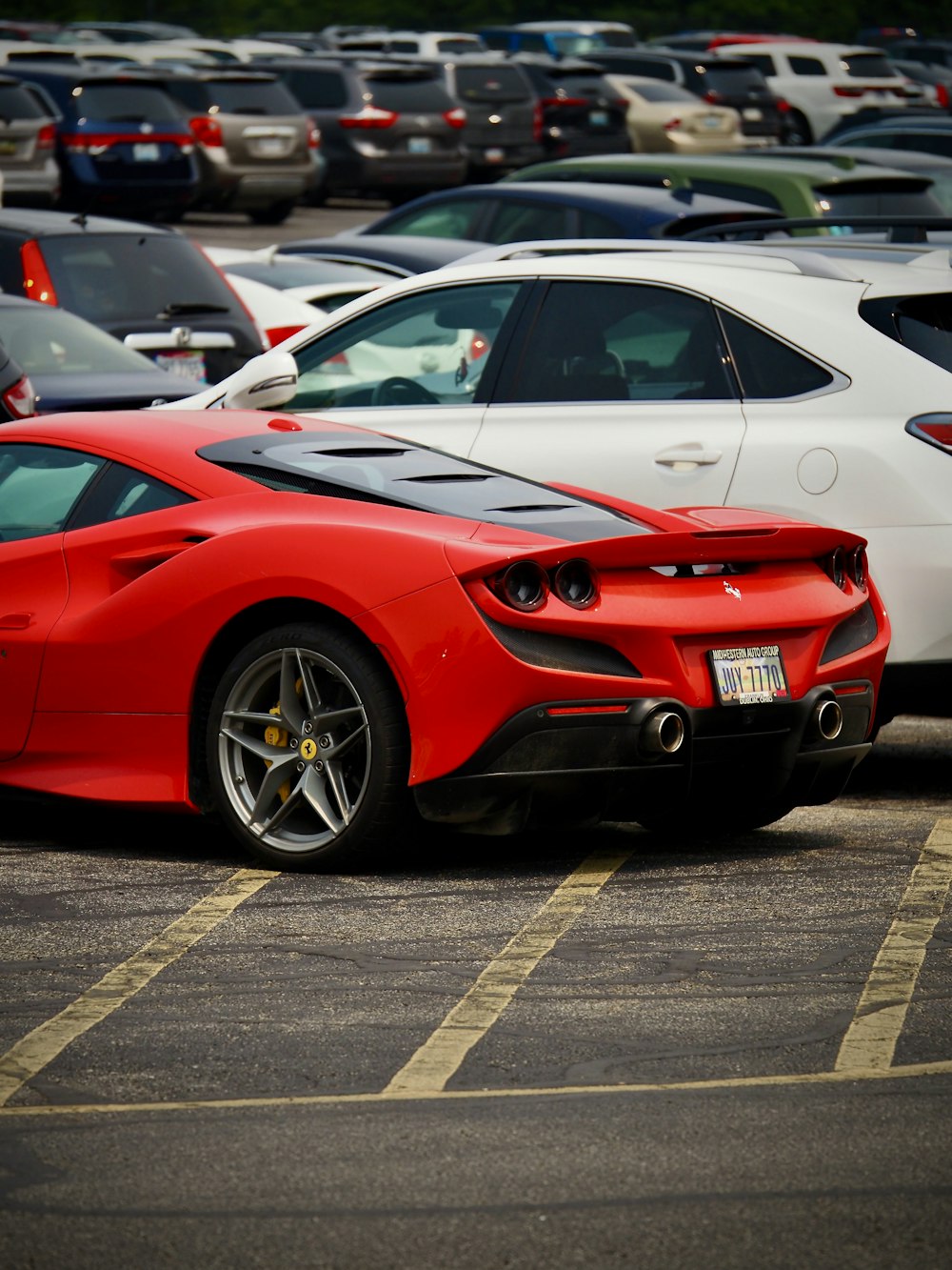 a red sports car parked in a parking lot