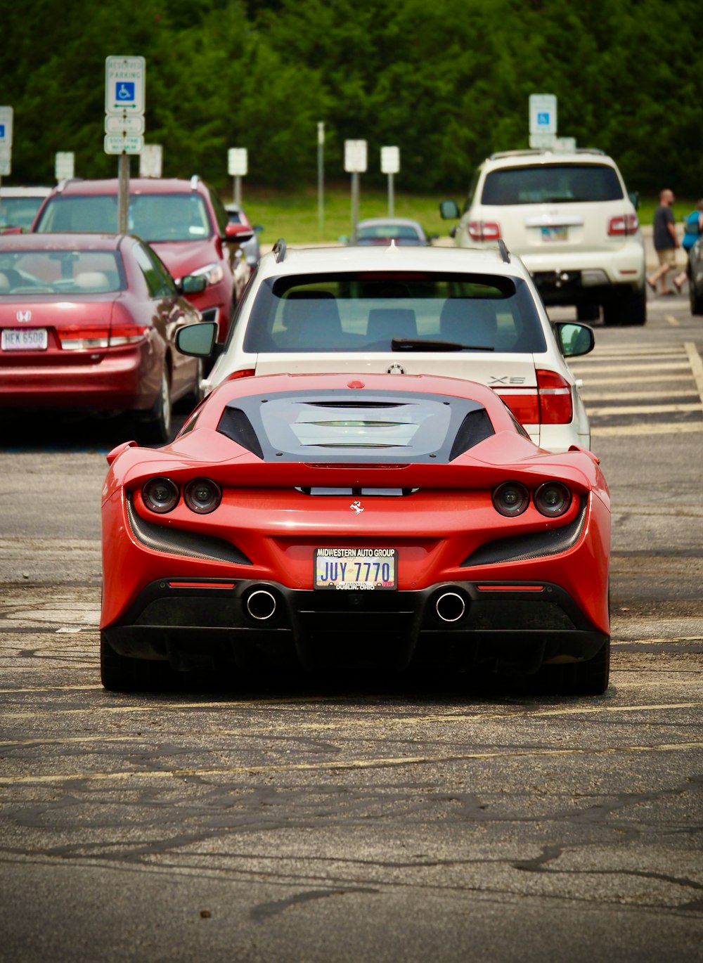 a red sports car parked in a parking lot