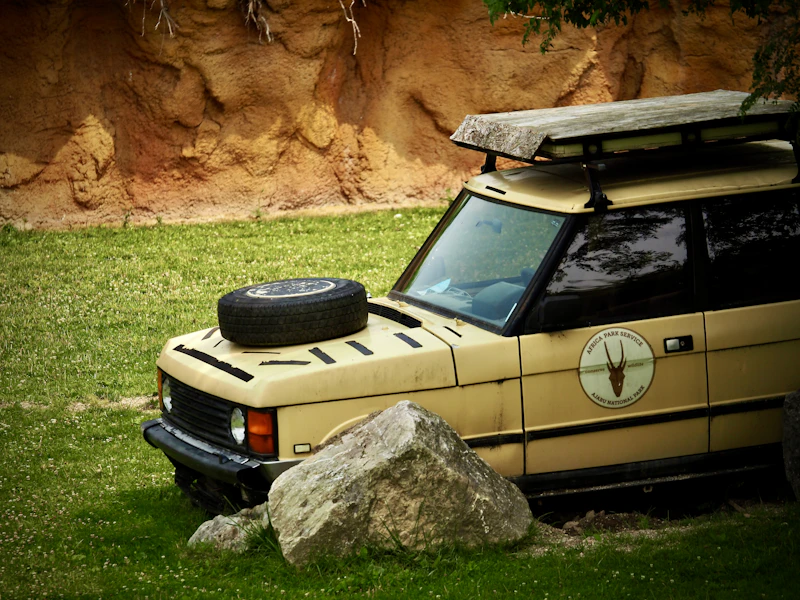 Safari vehicle stationed near rocky outcrops in the Tanzanian wild