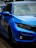 a blue car parked on the side of the road
