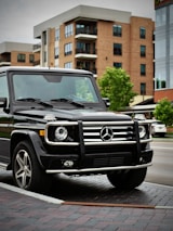 Urban NYC street scene with a G-Wagon parked beside a mural.