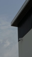 A high-tech security camera monitoring a modern industrial facility.
