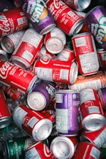 A close-up of refreshing soda cans with ice and condensation, showcasing variety.
