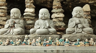 a group of buddha statues sitting next to each other