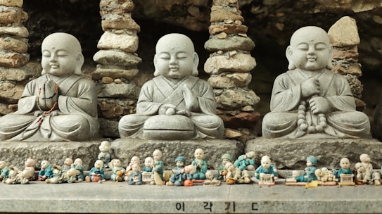 a group of buddha statues sitting next to each other