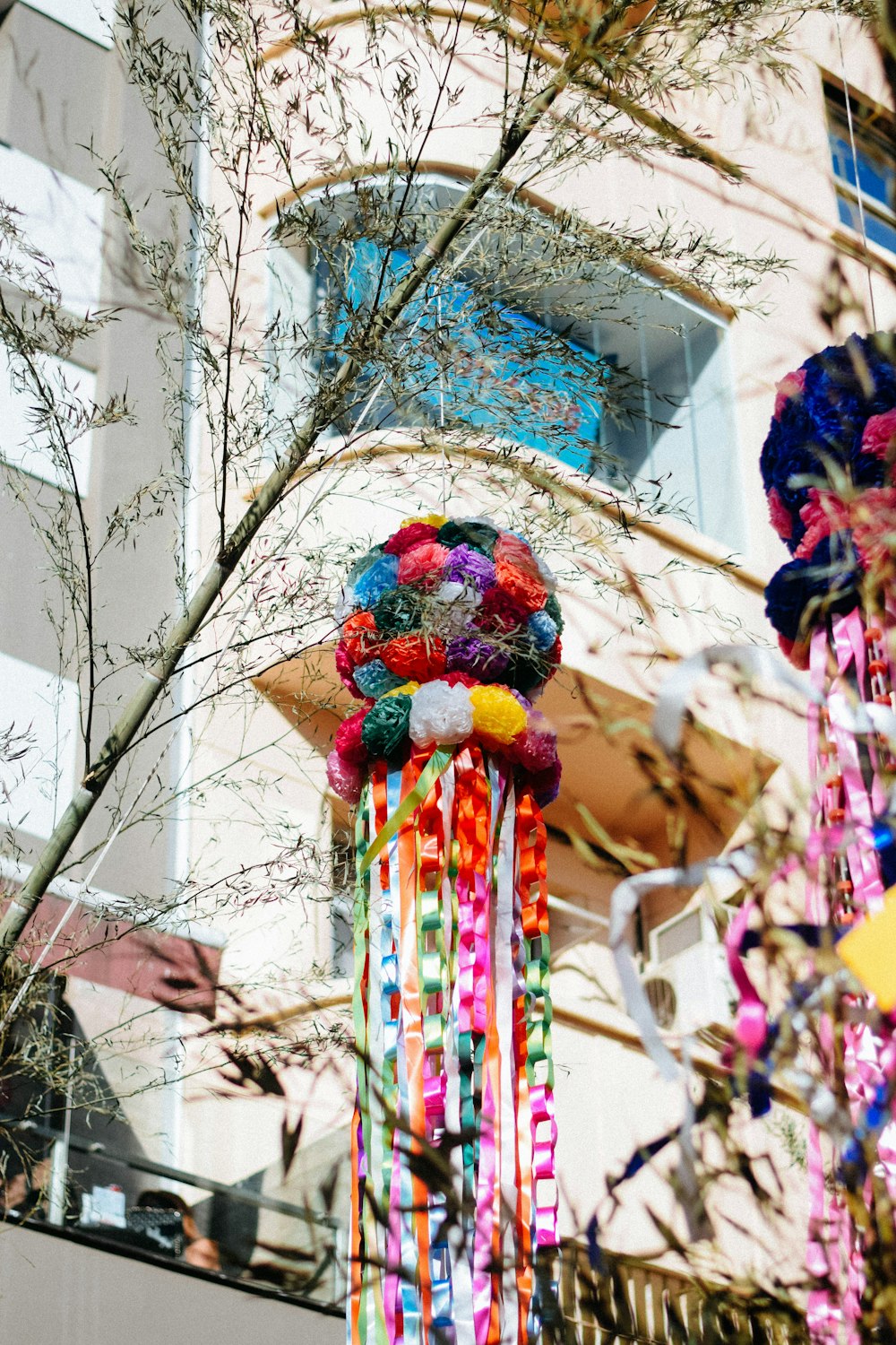 a bunch of colorful ribbons hanging from a tree