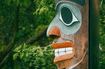 Close-up of intricate totem carvings with rich colors and textures.