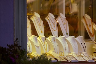 a row of white chairs sitting in front of a window