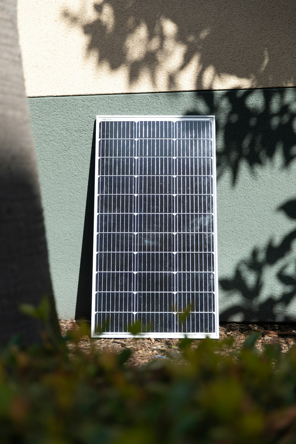 a solar panel sitting on the ground next to a building